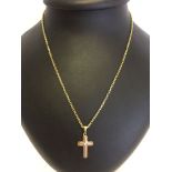 A 9ct yellow and white gold cross on a heavyweight 9ct gold chain. Cross set with a small diamond.