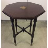 An Edwardian octagonal topped occassional table with turned legs and inlaid detail to top.