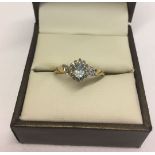 9ct gold dress ring set with a central aquamarine surrounded by small diamonds. Size O, total weight