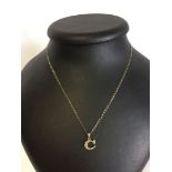 9ct gold pendant, initial 'C' set with clear stones, on a fine gold chain. Total weight approx 1.