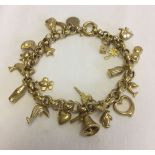 A charm bracelet with approx 21 charms. Bracelet stamped 375. Total weight approx 17.9g.