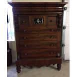 A large decorative Victorian chest of drawers/tallboy with mirror panel on central cupboard. Flame