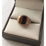 Hallmarked 9ct gold signet ring set with tiger's eye. Size K. Weight approx 2.9g.