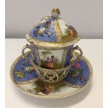 An 18th century Dresden (Meissen) lidded chocolate cup and trembluese saucer. Bears underglaze