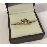 18ct gold & platinum trilogy ring set with 3 small diamonds in an illusion setting. Size J, total