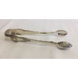 A pair of Victorian Edinburgh silver sugar tongs. Hallmarked Edinburgh 1851. Maker JW. Approx 62.