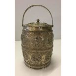 A silver indian lidded biscuit/tea barrel with hooped top handle. Fully engraved. 140mm high,