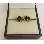 A pair of 9ct gold earrings, each set with 5 sapphires in a pretty setting.