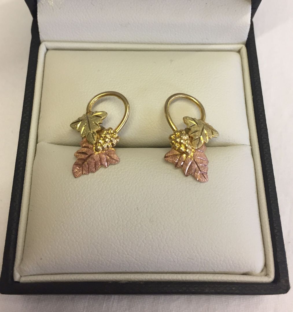 Three colour 12ct gold earrings with a grape vine design. Total weight approx 2.5g.