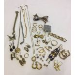 A collection of yellow metal costume jewellery including earrings and brooches etc.