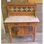 A vintage pine washstand with marble top & tile decoration to back. 103cm wide