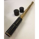 An antique 4 drawer telescope with leather case.
