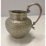 Silver indian jug with engraving and handle. 125mm high, 95mm diameter. Filled base.