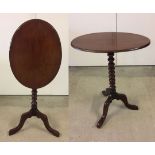 An oval tilt top mahogany tripod side table with bobbin support.