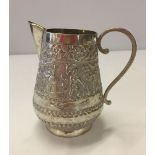 Silver Indian jug with engraving of a garden with men performing various things. 105mm high and 75mm