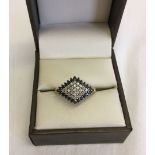 Ladies 9ct gold dress ring set twith black and white diamonds in a diamond shaped mount. Size P.