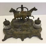 A painted bronze desk set with two glass inkwells and racehorse decoration. Signed A. Basso.