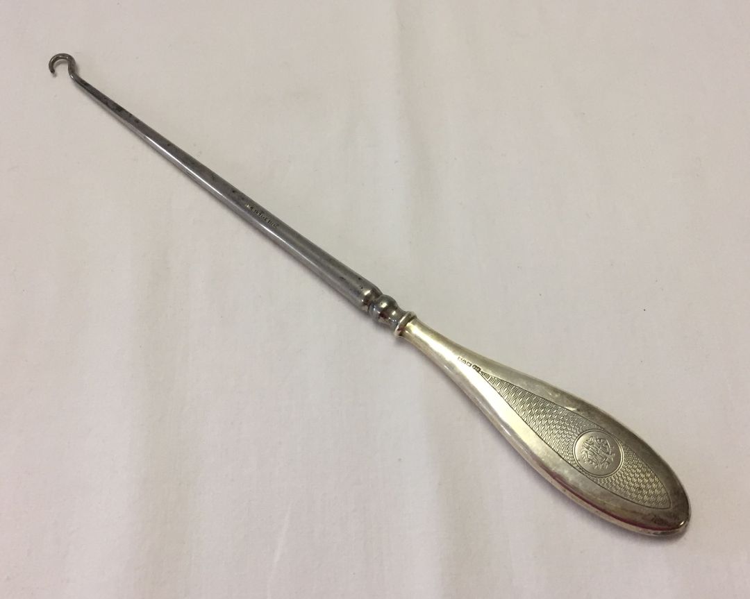 Silver button hook with monogrammed handle. Hallmarked for Chester 1914. 280mm long.