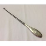 Silver button hook with monogrammed handle. Hallmarked for Chester 1914. 280mm long.