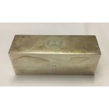 A rectangular lidded silver case. Cross in circle to lid, hallmarked London 1951. Weight approx