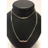 A silver chain 92cm long with lozenge shaped enamelled sections. Marked .925 silver. Weight approx