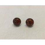 Pair of silver earrings set with amber stones with inclusions.