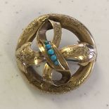Antique gold brooch in a bow design set with 5 turquoise in the centre, Tests as approx 12ct gold,