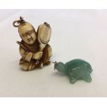 2 oriental pendants - a Jade carved turtle together with an oriental gentleman - possibly bone.