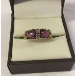 Antique 18ct gold ring set with 6 diamonds and 2 large ruby cabouchon stones. Maker Betts & Fairfax.