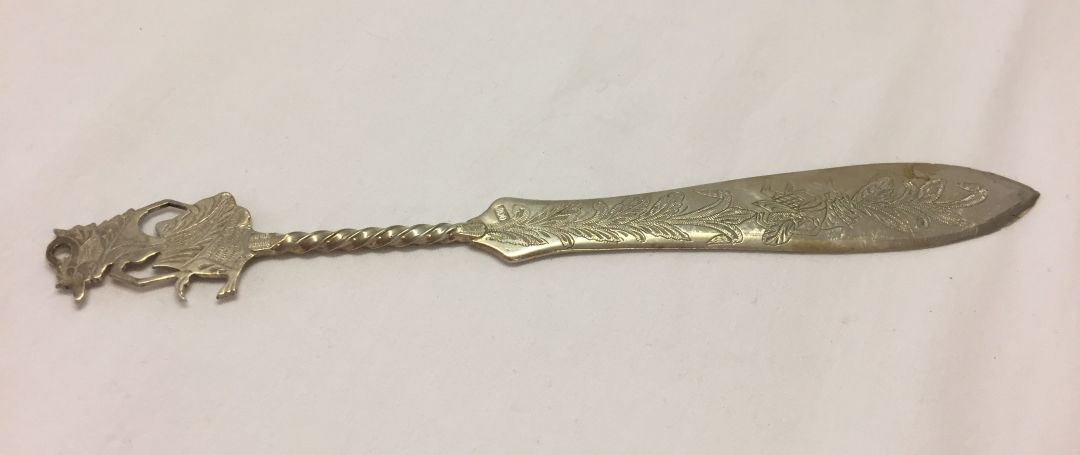 An Asian silver letter opener with engraved surfaces. Marked .800 on blade. Weight approx 32.6g.