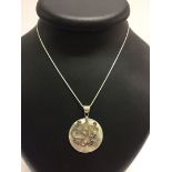 A mother of pearl shell pendant with a 925 bale and butterfly motif, on a rope chain.