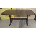 An Ercol dark wood dining table.