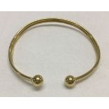 A 9ct gold torc style bangle. Approx 2.7g.