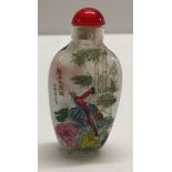 An interior painted oriental snuff bottle depicting scenes of birds sitting in trees.