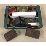 A box of mixed items to include tins, binoculars and horse brasses