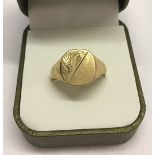 A 9ct gold mens signet ring, scroll decoration to top of ring. Size V, total weight 3.2g.