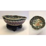 A handpainted Japanese bowl with dragon and Mount Fuji decoration on wooden base. Approx 25cm