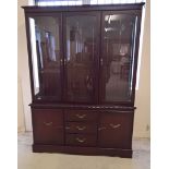 A modern dark mahogany coloured sideboard with glass doors, cupboards and drawers. Approx 136 x