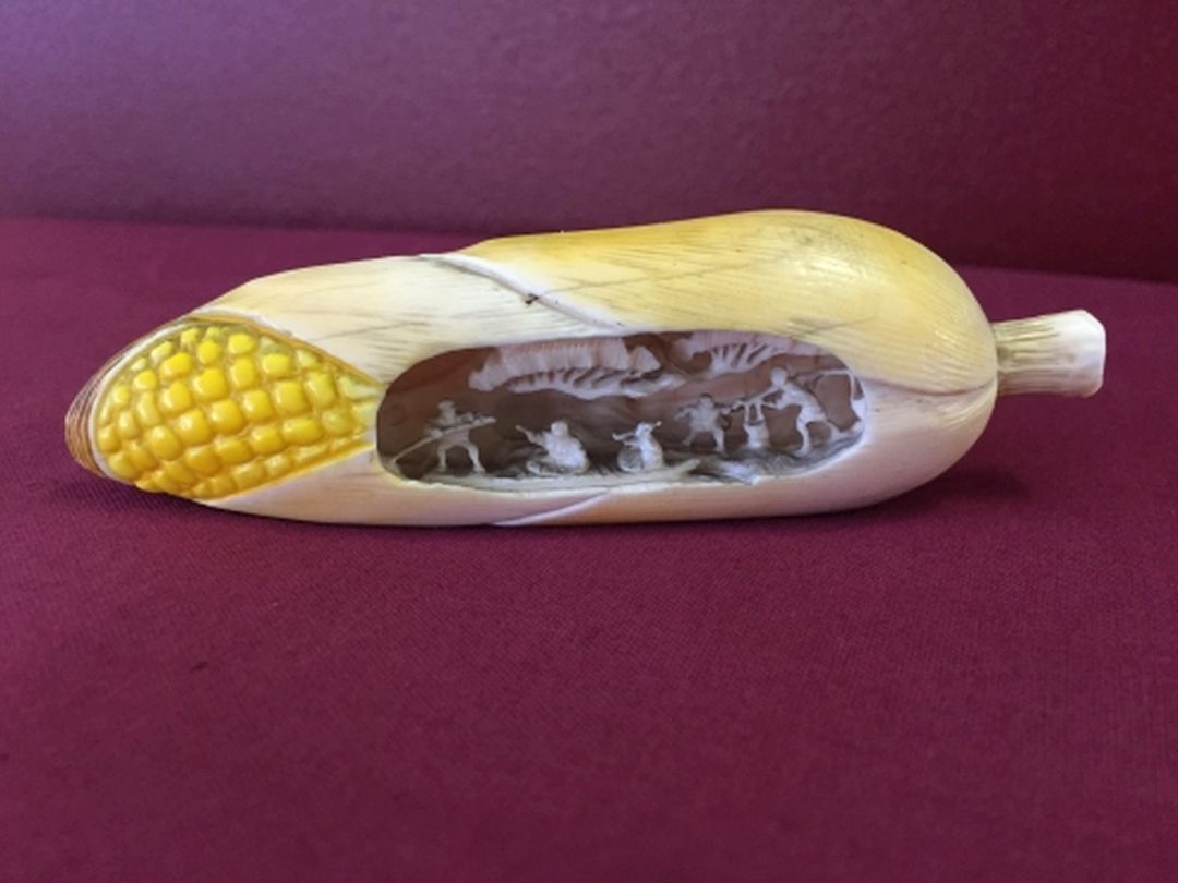 Meiji period Japanese ivory cob of corn with carved figural group to inside. 11cm long.