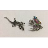 2 brooches set with marcasites. A lizard and a tropical bird with painted colours.