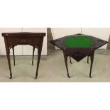 An Edwardian card table in mahogany with green baize top and fold out leaves.