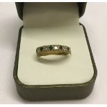 A 9ct gold emerald and diamond half eternity ring. Size N. Total weight 3.4g.