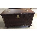 A dark wood chest with hinged lid and internal tray. Gilt coloured flower decoration and handles