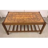 A c1970s brown tile topped coffee table. 87 x 47cm.