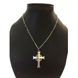 A white metal cross shaped pendant on a white metal chain.