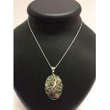 An abalone/paua shell pendant with scroll design & butterfly motif stamped 925, on a rope chain.