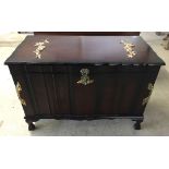 A dark wood chest with hinged lid and internal tray, gilt coloured flower decoration and handles.