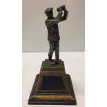 A c1930's pewter model of golfer Harry Vardon on wooden plinth a/f (club broken)