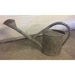 A large BAT galvanised watering can with rose.