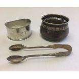 3 small metal items. A pair of Mappin & Webb silver sugar tongs HM 1893 Sheffield, a silver napkin